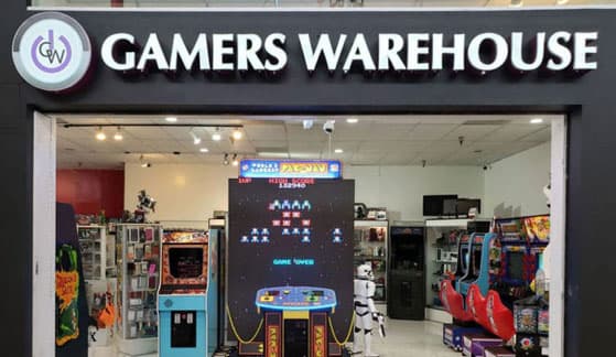 The Gamers Warehouse storefront inside Tucson Mall, arcade cabinets visible through the entrance